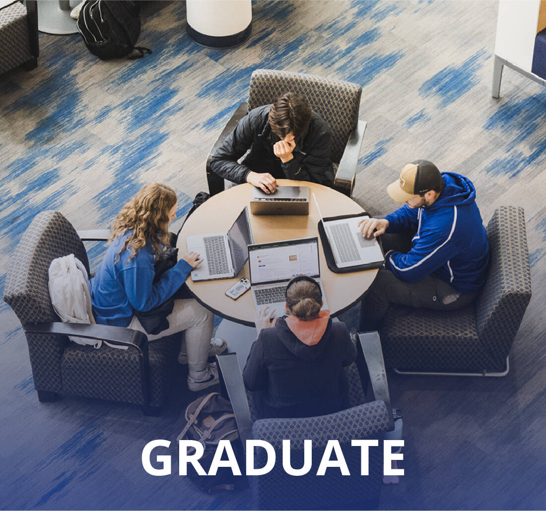 Group of four GVSU students working on laptops together